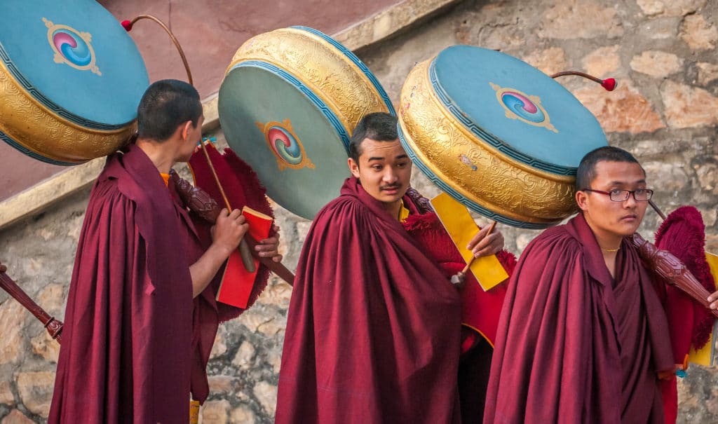 Monks holding chö nga drums